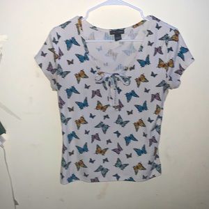 Ribbed short sleeve tee shirt with scoop neck and a tie in the front.